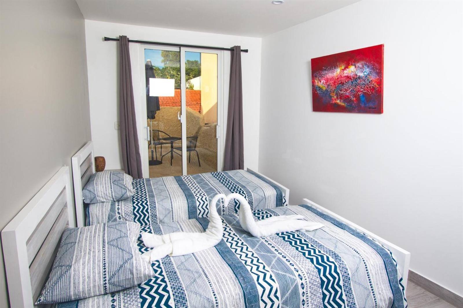 La Aldea 124: room with two beds and a door to the terrace